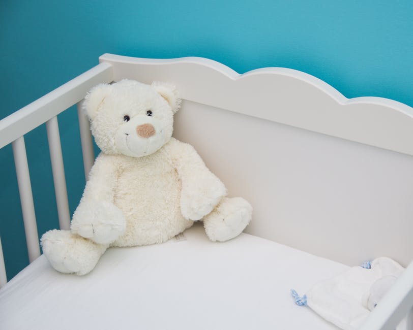 teddy bear inside the crib