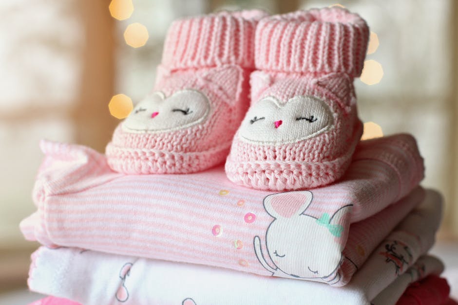 baby blanket and pair of shoes